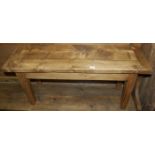 A rustic stained pine two seater bench, having cleated ends and of plain form, length 102cm