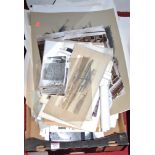 A box containing assorted monochrome photographs, pencil sketches, etc