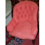 A mid-Victorian mahogany framed and floral button back upholstered tub armchair, raised on squat