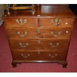 A George III mahogany chest of two short over three long graduated drawers, having pierced and