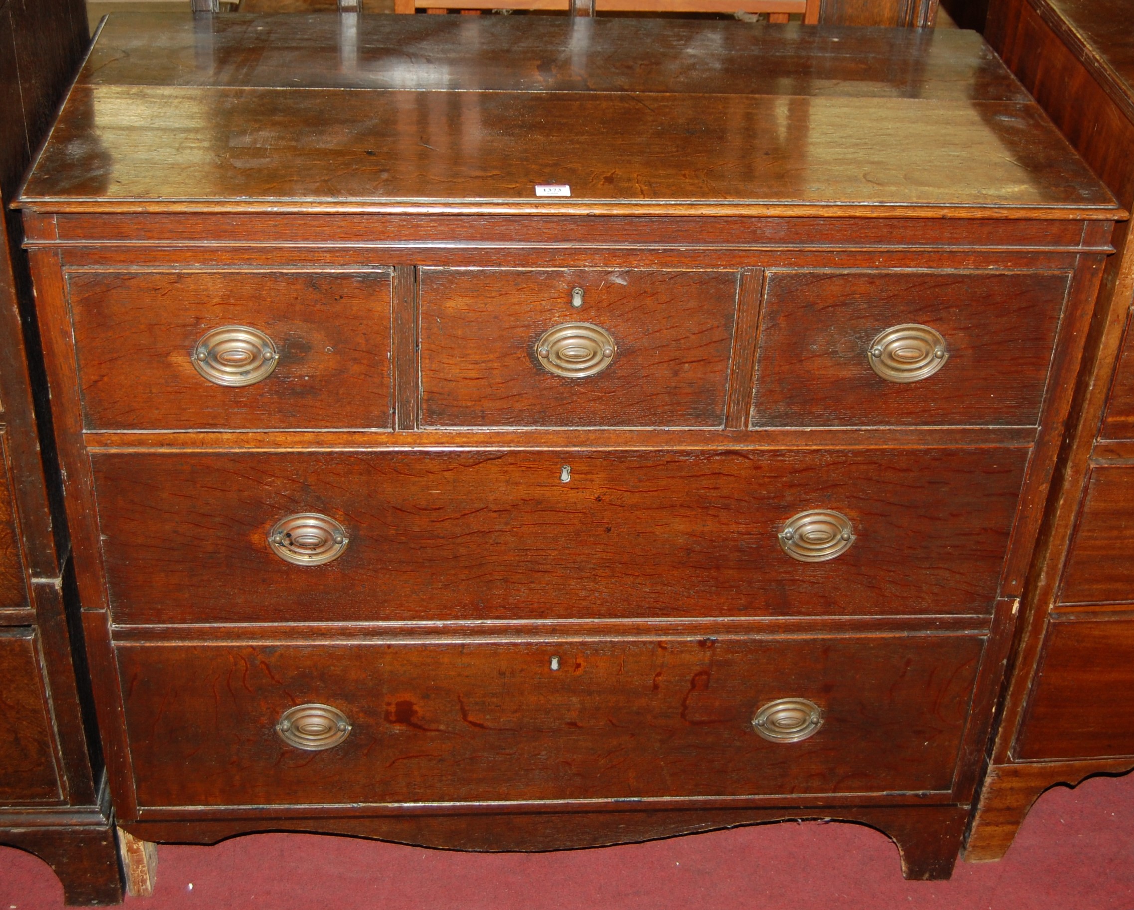 A 19th century oak dresser, the two-tier open plate rack over chest form base fitted with three