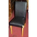A set of four contemporary beech framed and black leather upholstered dining chairs