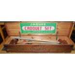 A mid-20th century Jacques croquet set, housed in a stained pine hinge-top box, with original