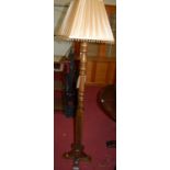 A contemporary Wood Brothers moulded oak standard lamp, the column of turned and square form, with