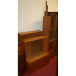 A 1970s teak extensive modular wall unit comprising; various glazed cabinets, fall front