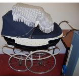 A mid-20th century Wilson painted metal and canvas baby's pram