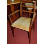 A 1960s Gordon Russell teak elbow chair, having drop-in pad seat, width 53cm