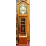 A contemporary teak cased grandmother clock, having arched brass dial, lead glazed trunk door,