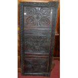 An antique relief carved oak panel, 135 x 56cm