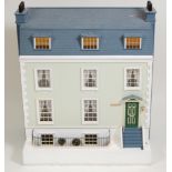 A large contemporary three-storey dolls house, having a faux slate roof and removable front, with