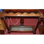 An early Victorian mahogany long stick stand, the wavy divisions raised on plain turned columns,