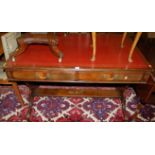 A mahogany and gilt tooled red leather inset two-drawer library writing table, raised on shaped