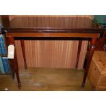 A mid-20th century mahogany fold-over baize lined card table, raised on turned tapering supports,