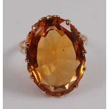 A yellow metal citrine dress ring, the oval citrine measuring approx 21.5 x 15.1 x 8.0mm, weight