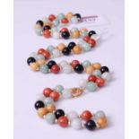 A multi-coloured jadeite bead necklace and matching bracelet, the necklace comprising 58 jadeite