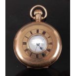 A gents 9ct yellow gold half hunter keyless wind pocket watch, having white enamel Roman dial and