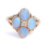 An 18ct yellow gold opal doublet quatrefoil cluster ring, with a centre round brilliant cut diamond,