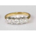 An 18ct gold diamond five stone ring, the claw set brilliants in a line setting, each weighing