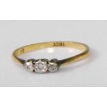 A circa 1920 18ct gold diamond three-stone ring, the graduated round cut illusion set diamonds