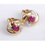 A pair of contemporary 9ct gold, ruby and diamond highlight set ear studs, the whole in a stylised