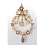 An Edwardian green peridot and seed pearl set openwork pendant, with ribbon surmount, 2.6g, unmarked