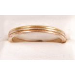 An 18ct Cartier 'Trinity' ring, comprising three bands of yellow, white and rose gold, finger size