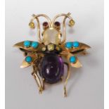 A circa 1900 yellow metal insect brooch, being multi-stone set with yellow diamond triple band to