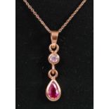 An 18ct yellow gold, ruby and diamond pendant, featuring a pear shaped ruby suspended from a round