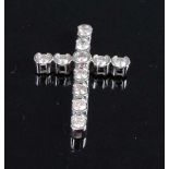 A 14ct white gold diamond set cross pendant, featuring eleven round brilliant cut diamonds in semi-