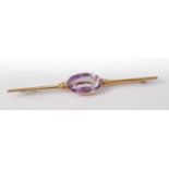 An 18ct gold amethyst set bar brooch, of good size, the oval cut amethyst measuring approx 16 x 9