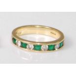 A contemporary 18ct gold, emerald and diamond half hoop ring, arranged as five channel set brilliant