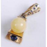 A modern 14ct gold, faux pearl and synthetic sapphire set pendant, with further synthetic sapphire