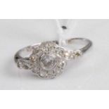 An Art Deco 18ct white gold and platinum diamond set ring, arranged as a centre old cut diamond