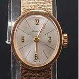 A ladies 9ct yellow gold Berkley manual wind wristwatch, having an oval silvered quarter Arabic dial