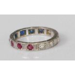 A white metal, ruby, diamond and sapphire set 'patriotic' eternity ring, arranged as four round cuts
