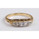 An 18ct gold diamond five-stone ring, the graduated old cut diamonds in a carved line setting, the