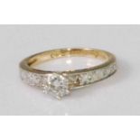 A contemporary 9ct gold diamond solitaire ring, the claw set brilliant weighing approx 0.45