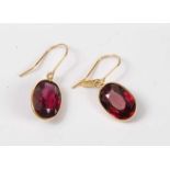 A pair of yellow metal rhodolite garnet drop earrings, each oval faceted garnet measuring approx