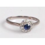 An Art Deco 18ct white gold and platinum, sapphire and diamond cluster ring, the round cut