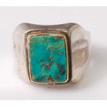 A heavy yellow and white metal turquoise signet ring, comprising a rectangular turquoise tablet in a