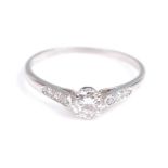 A white metal diamond solitaire ring, comprising a round brilliant cut diamond in an eight claw