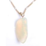An abstract polished opal pendant, dimensions approx 29 x 15mm, attached to a yellow metal figaro