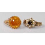 A 9ct gold cabochon amber set dress ring, 2.5g, size K; together with a 9ct gold garnet and seed