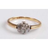 A circa 1920s 18ct gold diamond cluster ring, arranged as seven round cut diamonds in a flower