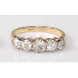 An 18ct gold and platinum diamond five stone ring, the graduated claw-set old cut diamonds in a line