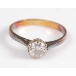 A yellow and white metal single stone diamond ring, featuring a round brilliant cut diamond in a
