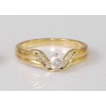 A contemporary 18ct gold diamond solitaire ring, the four claw set brilliant weighing approx 0.2