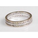 A contemporary 18ct yellow and white gold diamond eternity ring, arranged as two rows of channel set