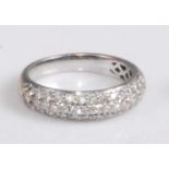 A contemporary 18ct yellow and white gold diamond half eternity ring, arranged as three rows of pavé