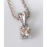 A platinum diamond set pendant, the four-claw set brilliant weighing approx 0.15 carats, the whole